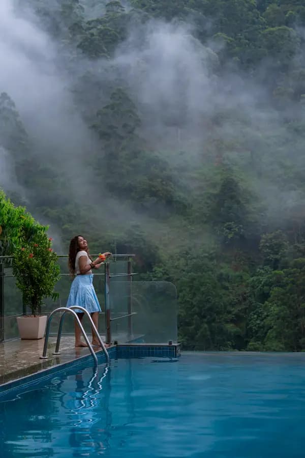 Pool set against the Attukad Falls backdrop